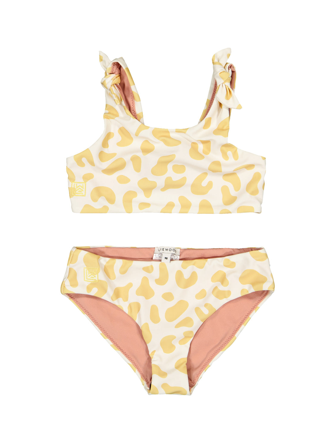 Bikini Cremeweiß: Zweiteiliger Bikini mit Tank-Top und breiten Trägern, knotbare Schulterdetails, mid-rise Slip. Weiß mit gelben Fleckenmuster, pinkes Innenfutter.