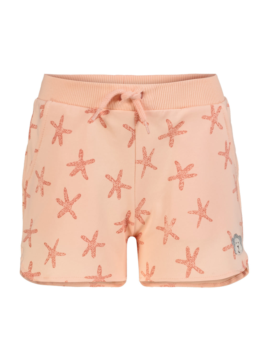 Kinder-Sweatshorts Apricot mit Seesternmuster, elastischem Bund und Zugband, Bärenapplikation auf einem Bein. Ideal für sportliche Aktivitäten, erhältlich bei bellybutton.