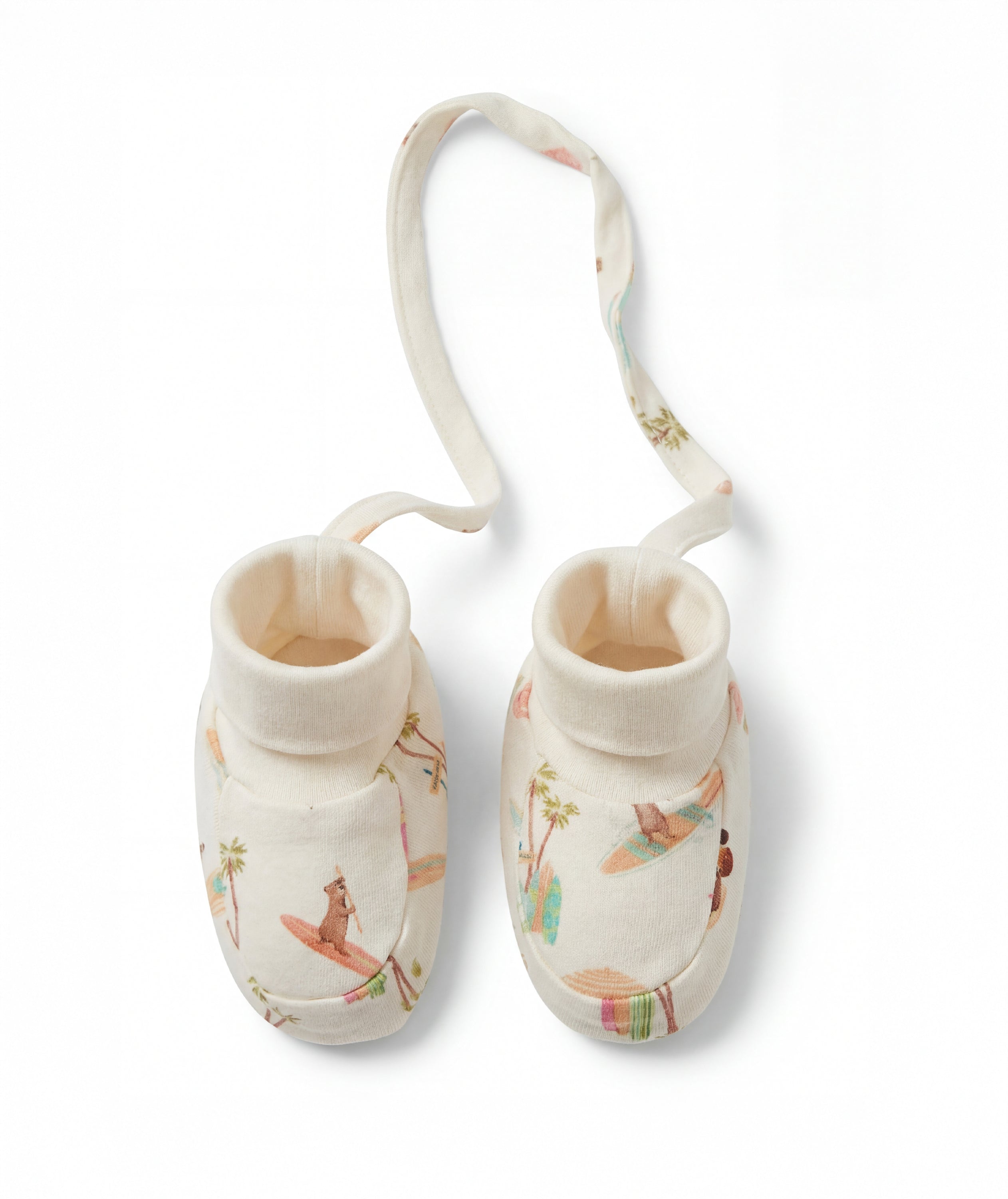 Pair of baby booties with a strap on a white background