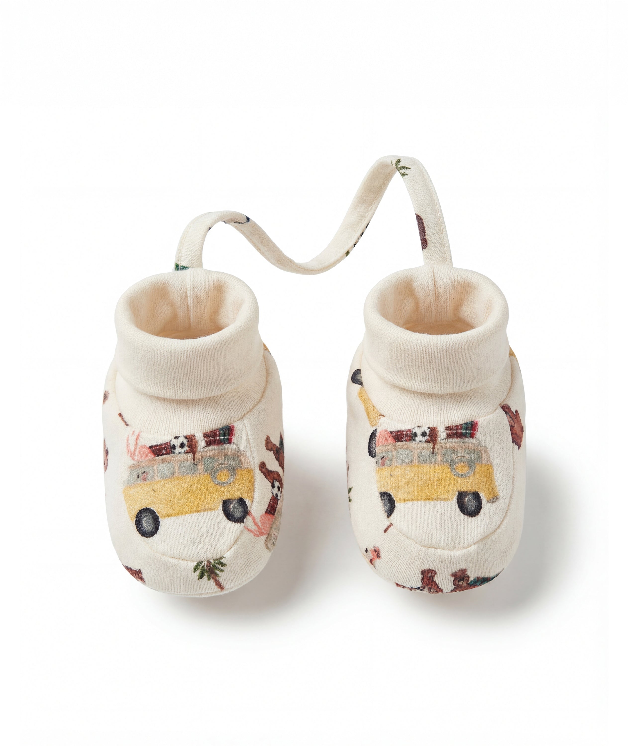 Pair of baby shoes with vehicle pattern on a white background